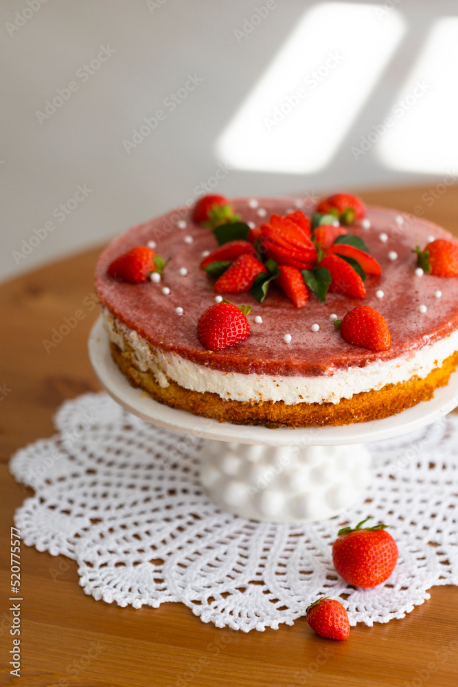 Obraz premium Homemade holiday strawberry cake with cottage cheese creamst and strawberry confit decorated with fresh berries