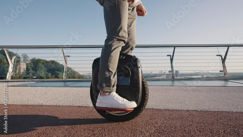 Pensioner rides electric unicycle trying to keep balance photo
