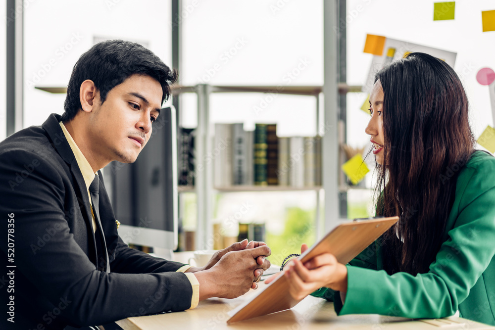 Asian business man and woman meeting analyzing and discussing strategy with startup project.Creative business people plan and brainstorm with desktop computer on conference in office.Teamwork Asian business man and woman meeting analyzing and discussing strategy with startup project.Creative business people plan and brainstorm with desktop computer on conference in office.Teamwork