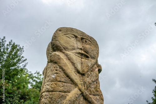 This is a bronze age stone carviing with two faces called Janus  located In Caldragh Cemetery on Boa Island  Lower Lough Erne. Northern Ireland