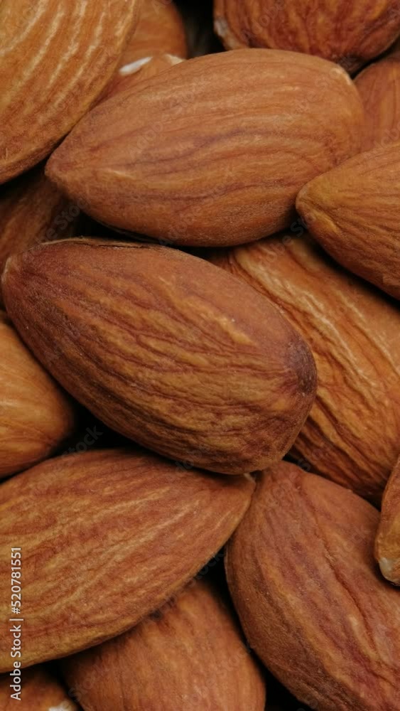 Vertical Resolution Video, Top view almonds nuts rotation, close up.	
