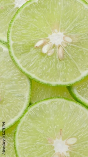 Vertical Resolution Video, Top view limes slices rotation, close up.