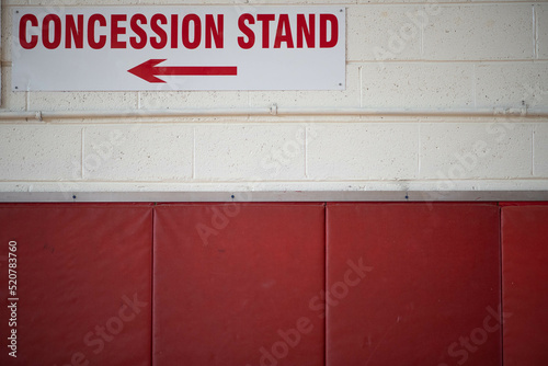 Concession stand sign on a block wall.