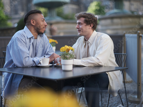 UK, South Yorkshire, Gay couple enjoying coffee at cafe table