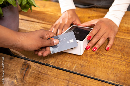 UK, London, Close-up of customer paying with credit card at cafe photo