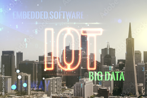 Double exposure of abstract virtual IOT hologram on San Francisco city skyscrapers background, research and development concept