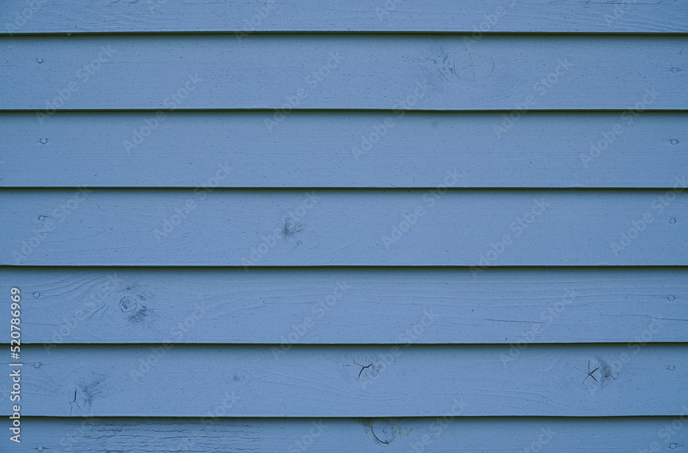 Fototapeta premium Blue wood background. The wall of the house made of blue wooden boards.