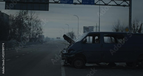 Burnt car on the street of a ruined Ukrainian city