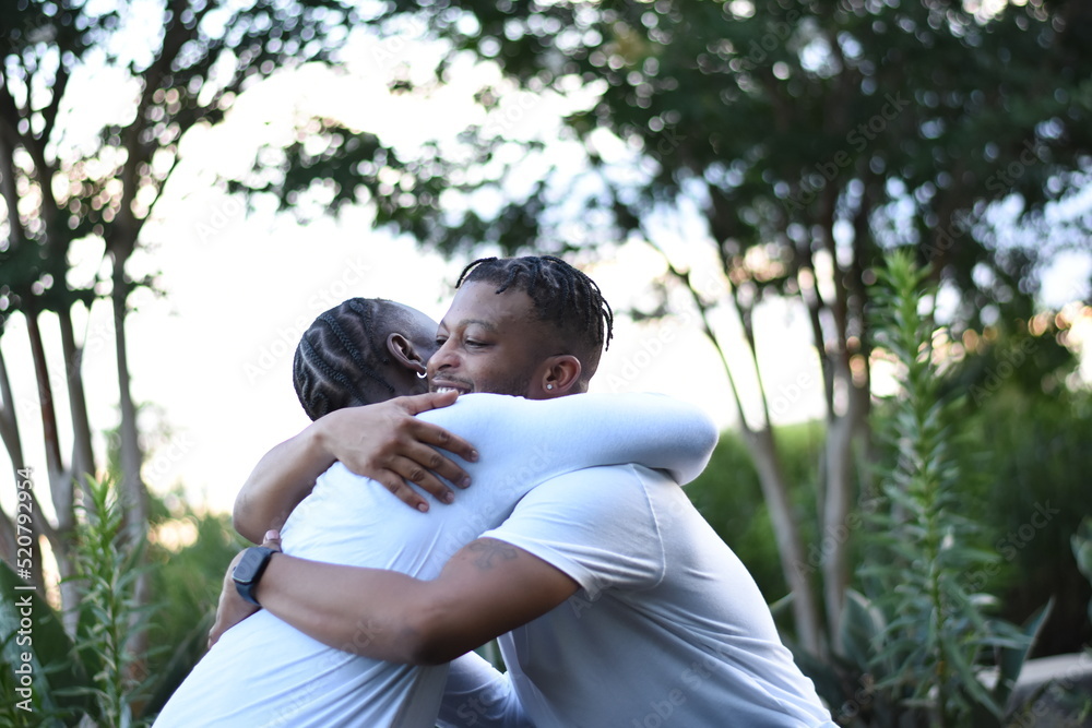 USA, Louisiana, Gay couple hugging in park USA, Louisiana, Gay couple hugging in park