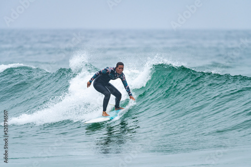 Surfer girl riding a wave © homydesign