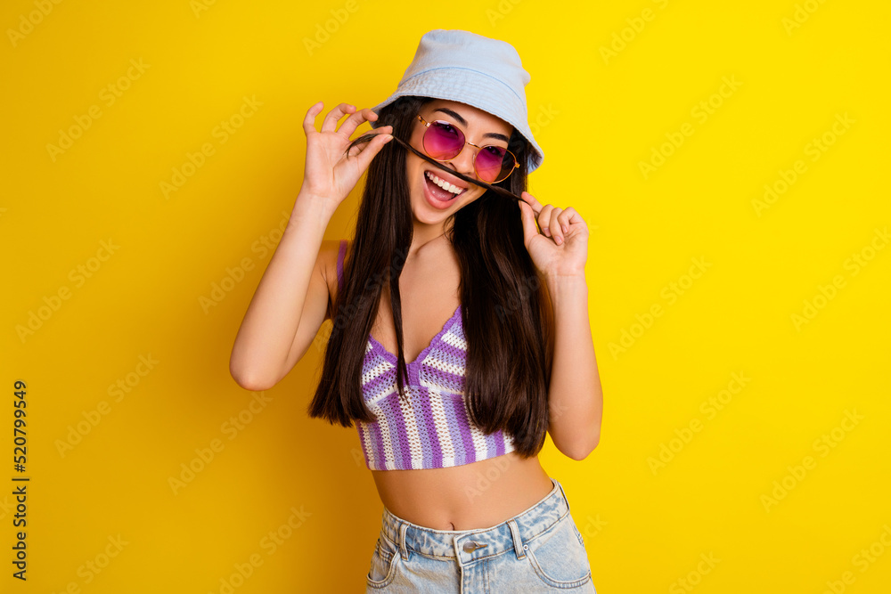 Photo of adorable funky girl dressed swimsuit bra cap making hair fake mustaches isolated yellow color background Photo of adorable funky girl dressed swimsuit bra cap making hair fake mustaches isolated yellow color background