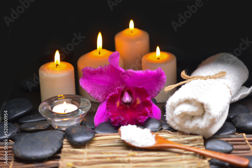 bath relaxation and body treatment on straw, mat, black stones 
