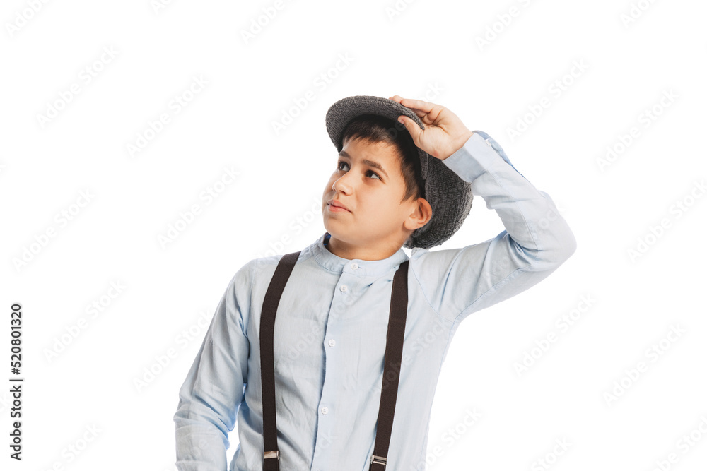 Portrait of boy, child in shirt, cap and suspenders posing isolated over white studio background. Vintage fashion Portrait of boy, child in shirt, cap and suspenders posing isolated over white studio background. Vintage fashion