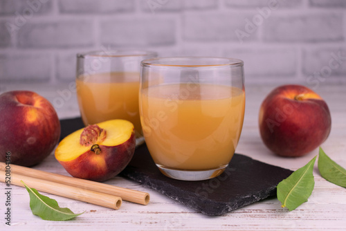 Fresh peach juice in low glasses.
