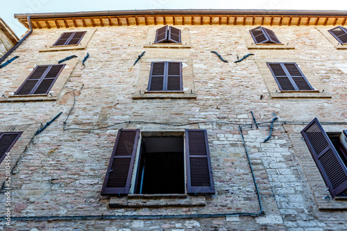 Facade of an old building in the historic center of Assisi, Umbria, Italy, Europe