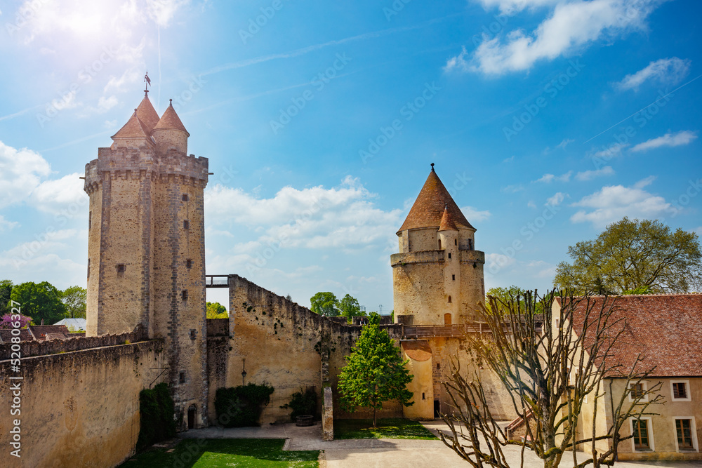 View from walls on towers of Blandy-les-Tours castle over sky