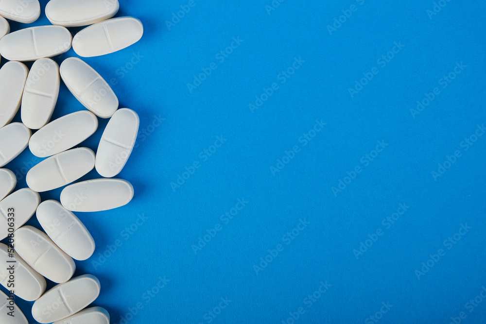 Pills on blue background with copy-space. Place for text
