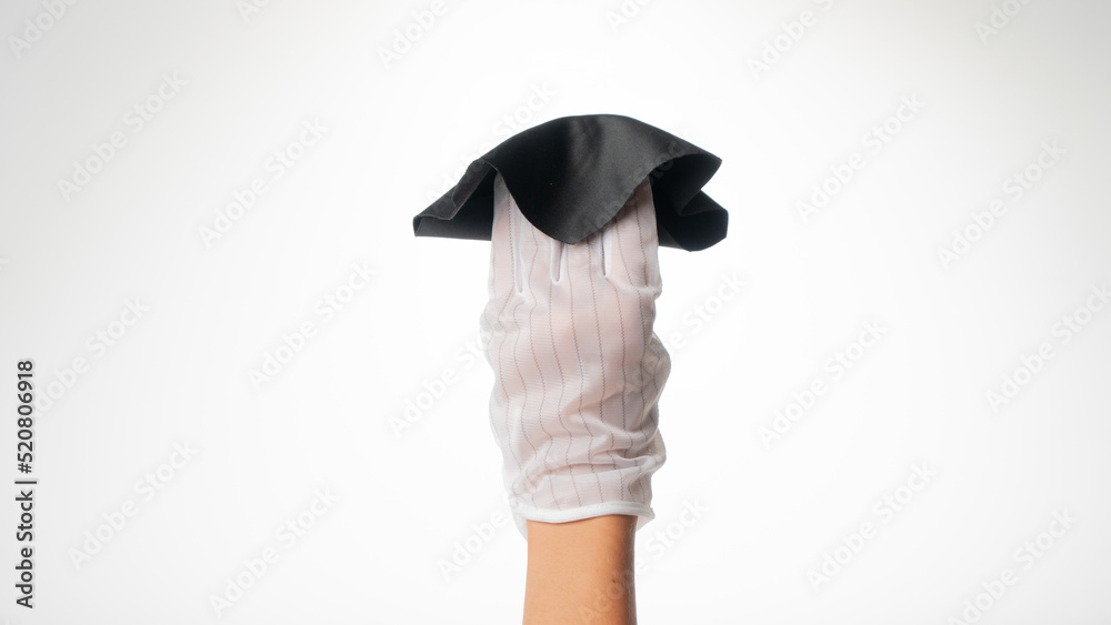 Hand in a white hygienic glove with a cloth for wiping monitors Hand in a white hygienic glove with a cloth for wiping monitors