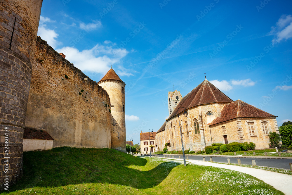 Saint-Maurice church and walls of Blandy castle in France