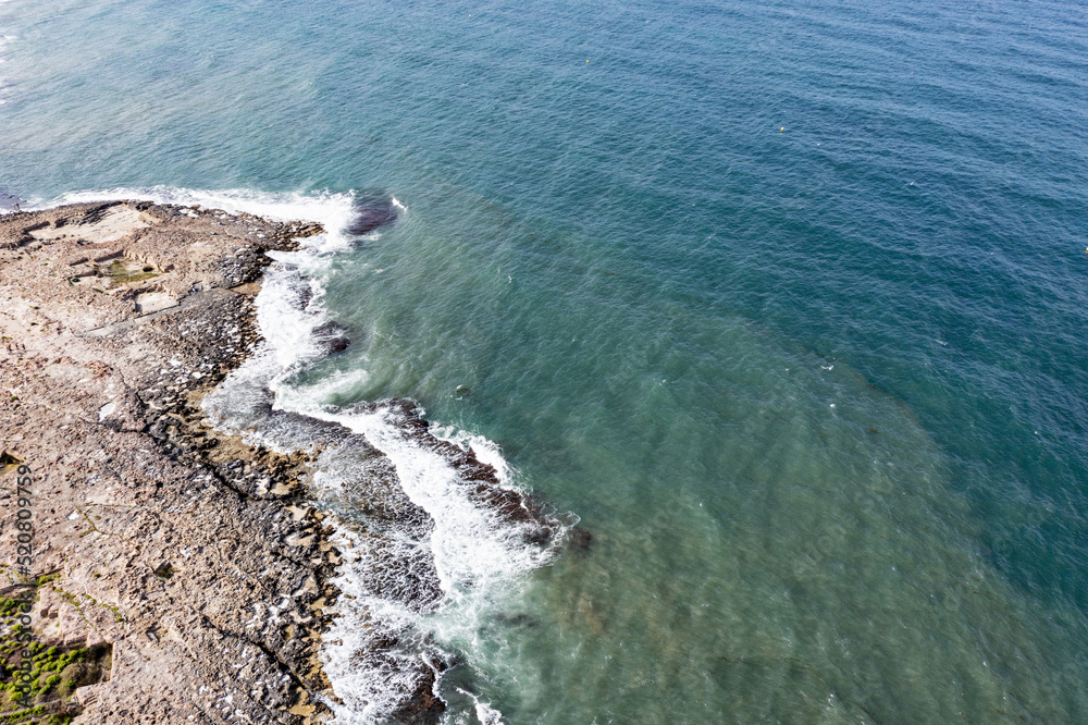 Aerial view of waves splashing on beach