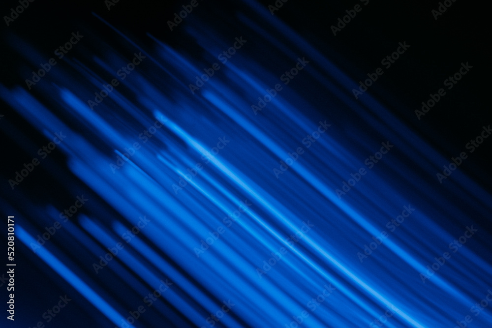 Blur fluorescent light. Futuristic rays. Cyber glare. Defocused neon ultraviolet navy blue color laser beam flare motion on dark black modern abstract background.