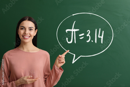 Female teacher near blackbo...