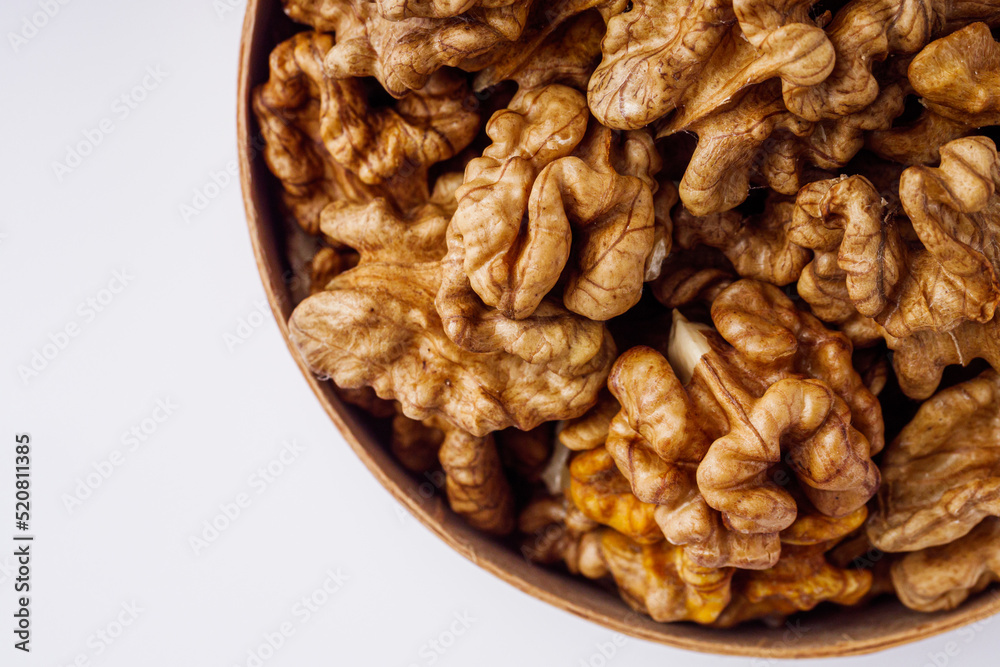 dried walnuts on a white acrylic background dried walnuts on a white acrylic background