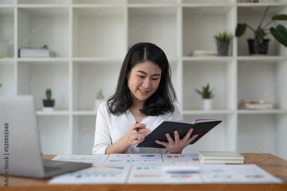 Business asian female working on laptop conputer at home office.
