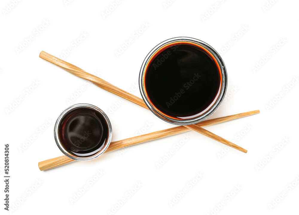 Bowls of soy sauce and chopsticks on white background Bowls of soy sauce and chopsticks on white background