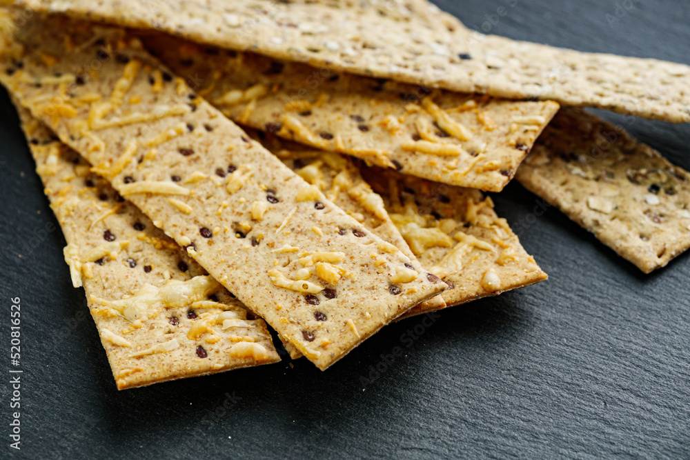 Fototapeta premium diet crispy bread on a black stone background