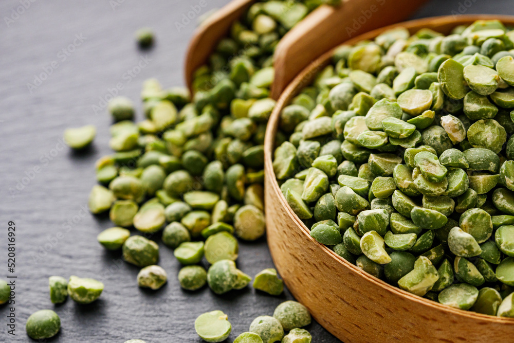 dried green peas on a black stone background dried green peas on a black stone background