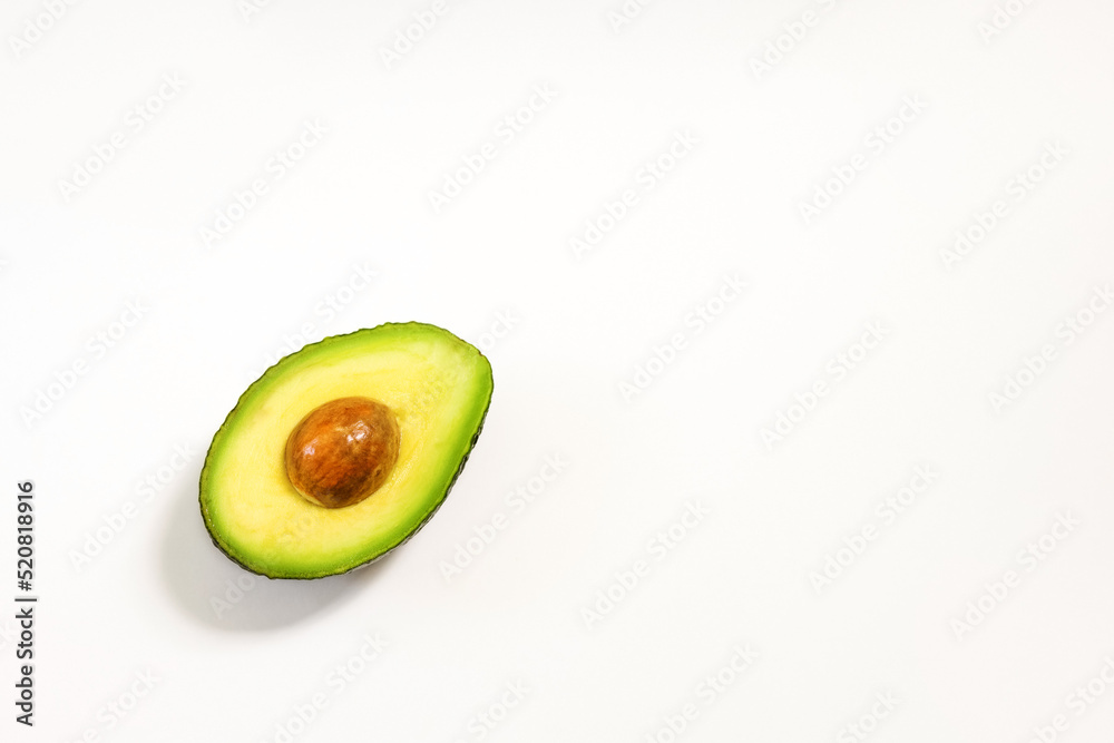 Avocado halves on a white background for healthy nutrition