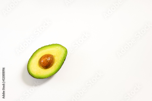 Avocado halves on a white background for healthy nutrition