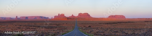 Scenic Road in the Dry Desert with Red Rocky Mountains in Background. Sunrise Sky. Forrest Gump Point in Oljato-Monument Valley, Utah, United States. Panorama