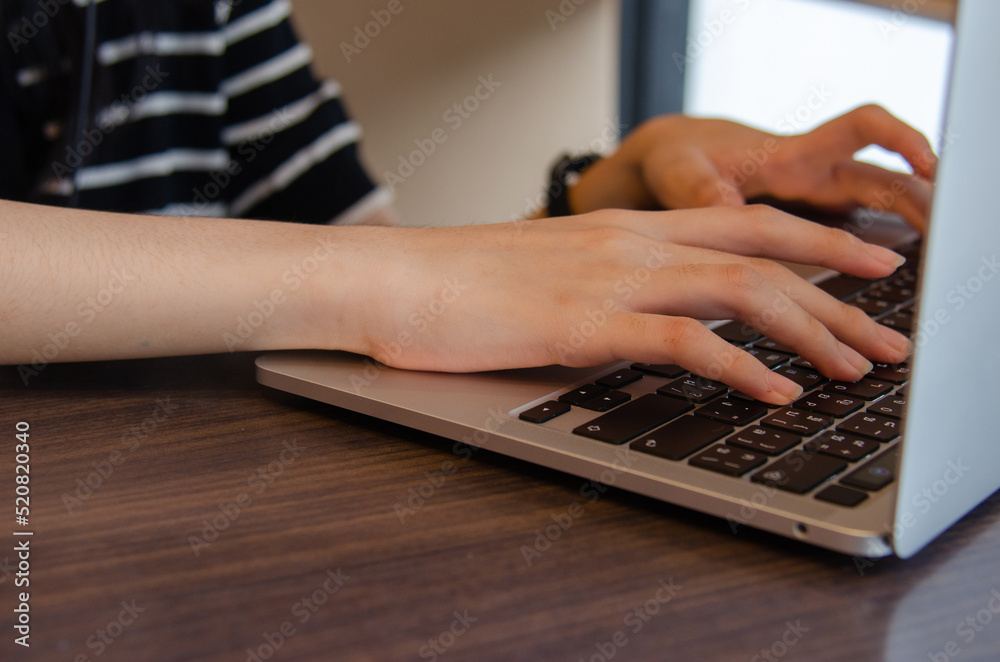 close up hand girl typing keyboard computer laptop digital online network communication internet on table. close up hand girl typing keyboard computer laptop digital online network communication internet on table.
