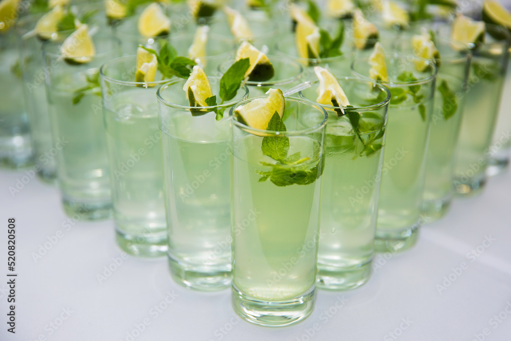 glasses with refreshing drinks with lime