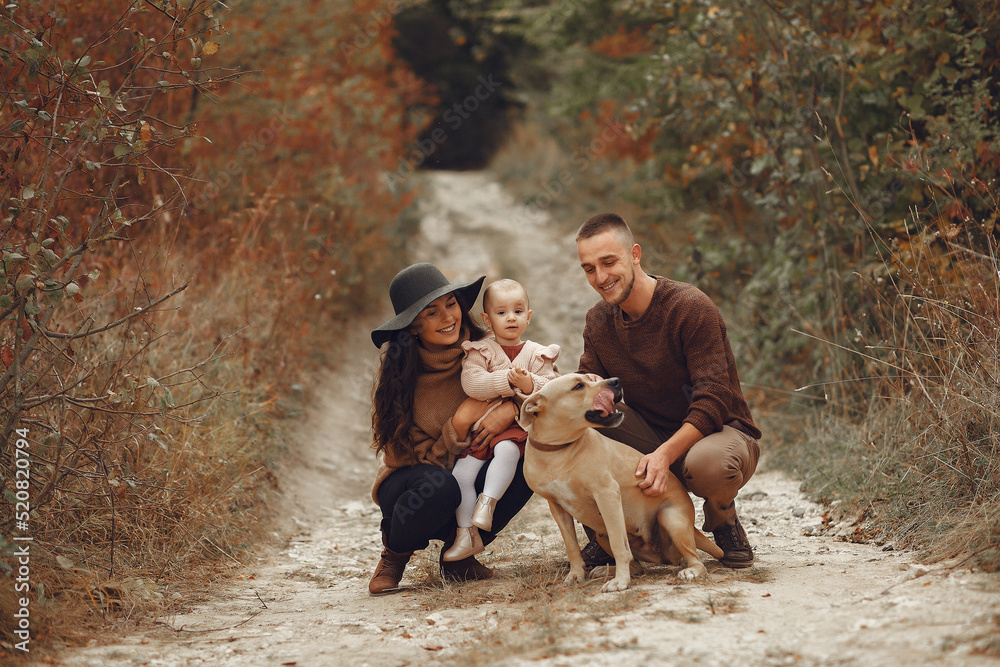 Cute and stylish family playing in a autumn field Cute and stylish family playing in a autumn field