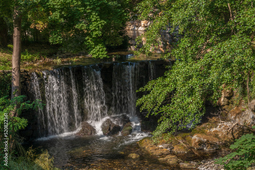 Scenic summer landscape of waterfall amidst green foliage in the Boulzane river valley  Gincla  Aude  France