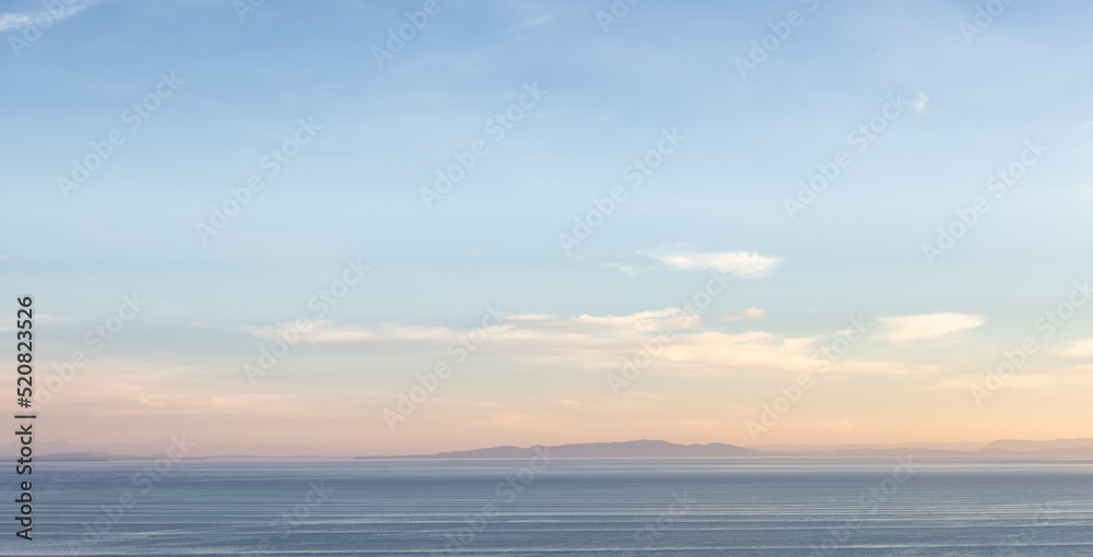 Fototapeta premium Panoramic View of Cloudscape during a colorful sunset or sunrise. Taken on the West Coast of British Columbia, Canada.
