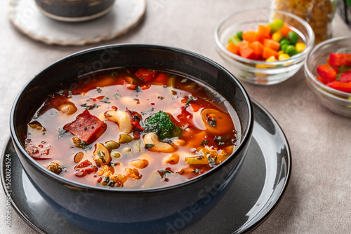 Minestrone Soup is a thick soup of Italian origin made with vegetables, often with the addition of pasta or rice.