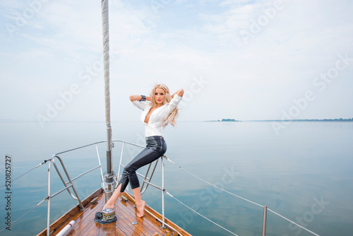 girl posing on a yacht.portrait of a sporty girl on a yacht © serhii