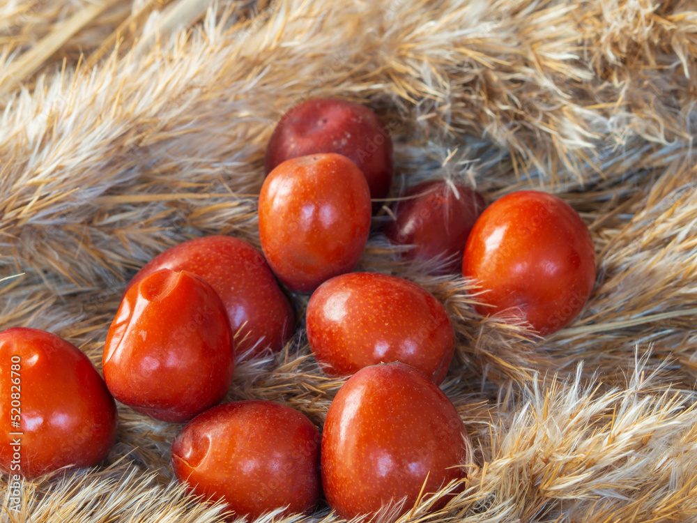 Ripe juicy unabi berries (ziziphus) close-up. Shiny orange fruit marmalade- jujube Ripe juicy unabi berries (ziziphus) close-up. Shiny orange fruit marmalade- jujube