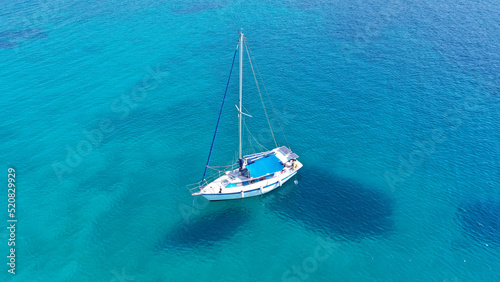Aerial drone photo of sail boat anchored in deep blue Aegean sea, Greece