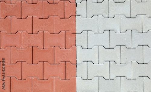 Red and gray interlocking concrete paver blocks. Tiles for outdoor pavement. Samples. background and texture