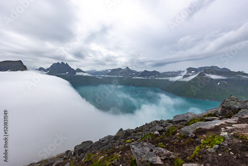 foggy view of the Fjordgard from Hesten trail to the Segla mountain on Senja island in northern Norway. photo