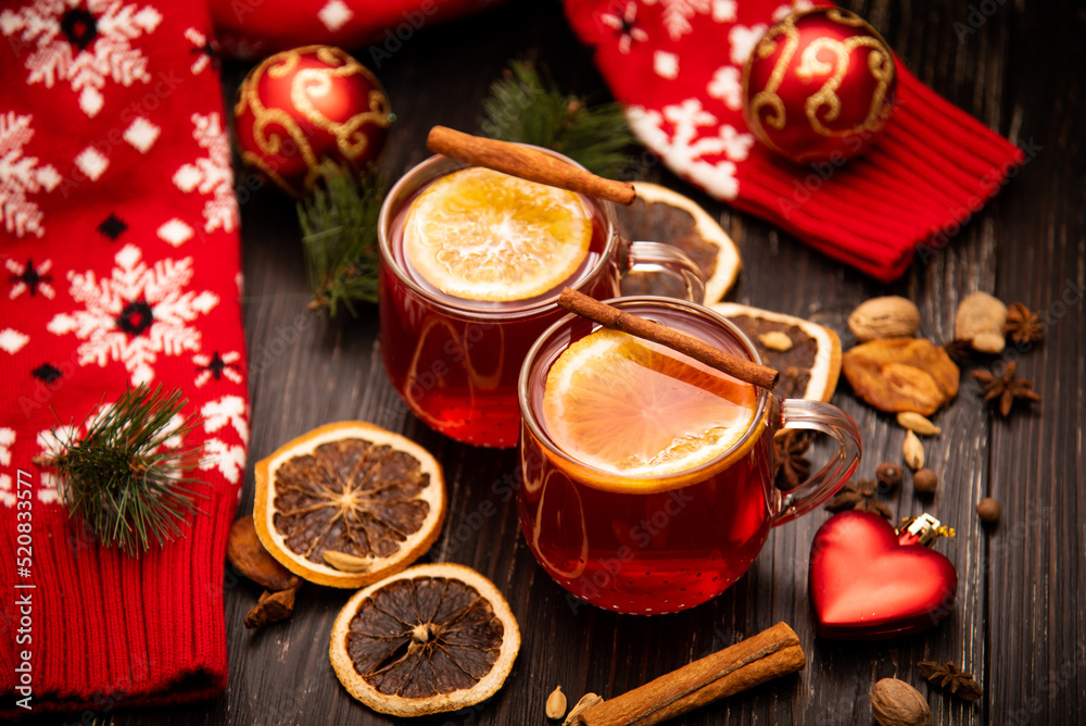 Fruity mulled wine on a wooden background with spices.