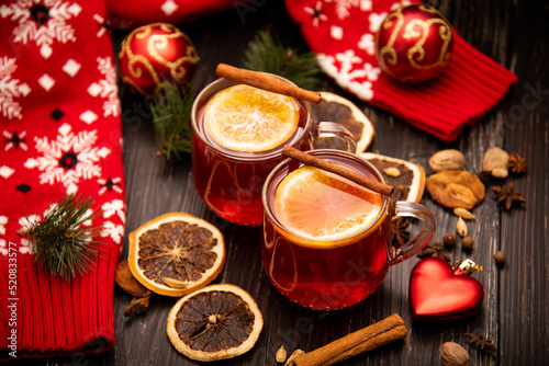Fruity mulled wine on a wooden background with spices. © Natalya Temnaya