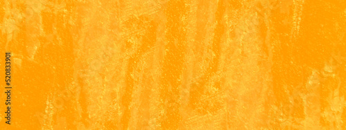 Abstract grainy messy warm grunge splashed orange background with seamless vintage grunge texture, beautiful and bright orange or yellow background for wallpaper and design.