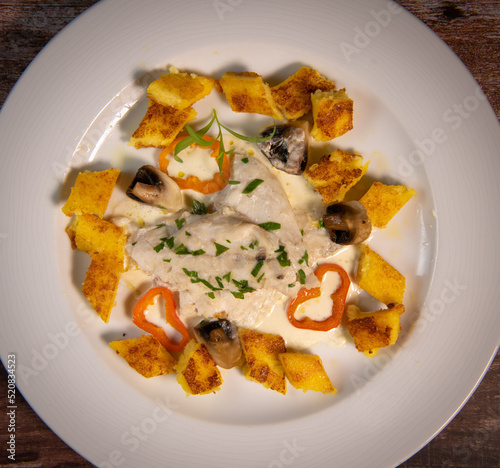 Recipe for sea bass fillet with fried polenta and white wine sauce. High quality photo