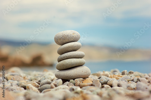Stack of pebble stones with sea on the background